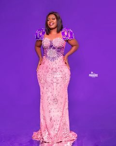 Rose sequin mermaid gown with sculpted violet shoulders and a crystal-beaded bodice.